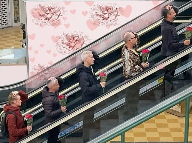  …VALENTINE’S DAY. Where we will open on a MEDIUM PROFILE and the camera will PULL BACK…and BACK, until we see all ALL FIVE of our LADS, with identical haircuts, identical date clothes and identical sad-looking flowers. And it is in that moment that 