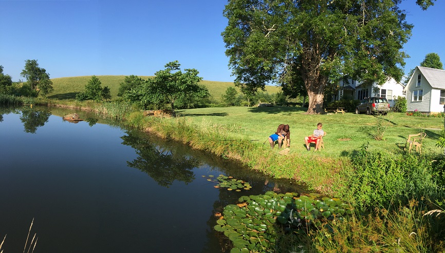 Fish pond at farm with grandsons fishing
