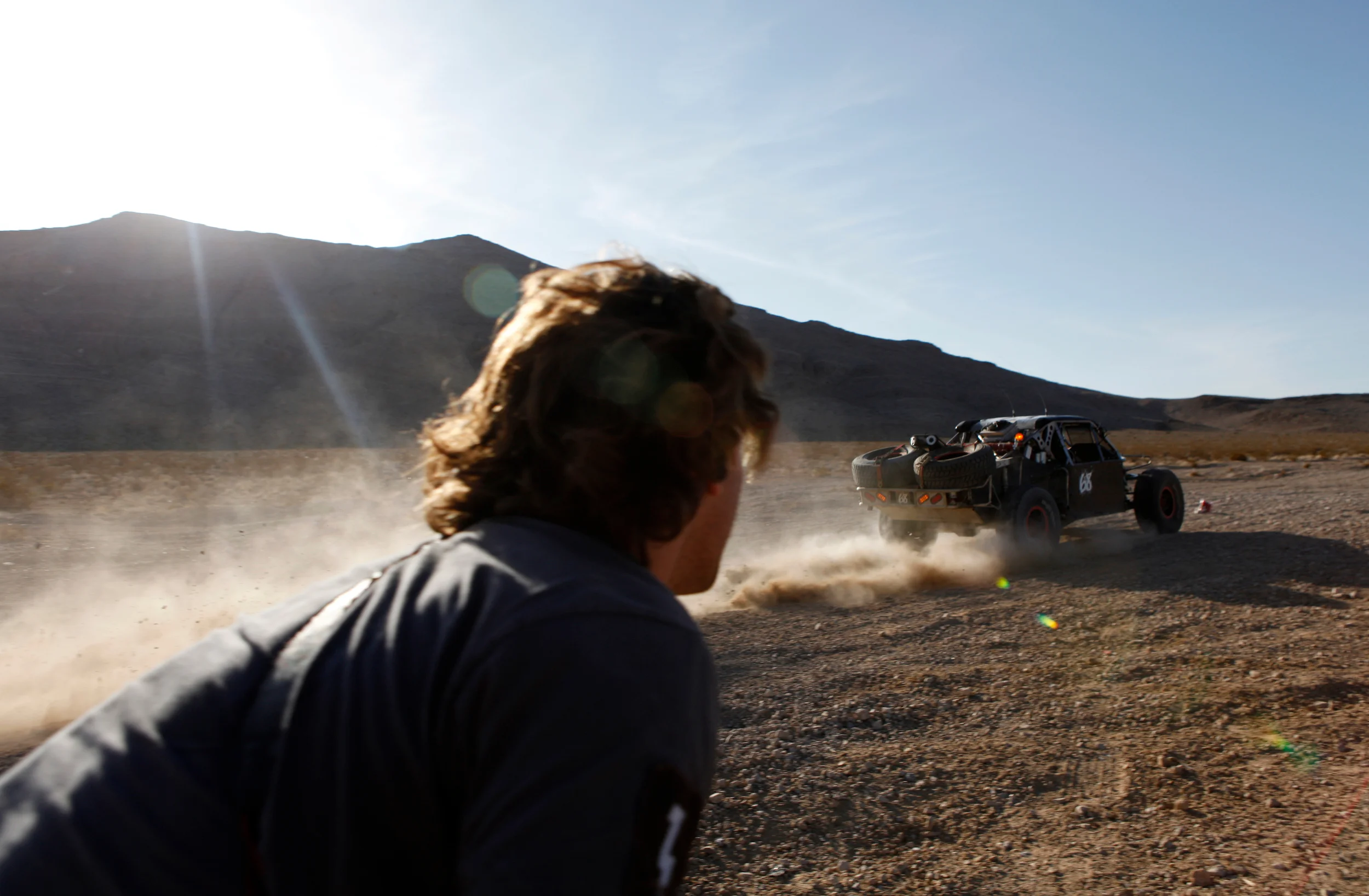  Crew watch the race truck whiz by at speeds reaching 100mph during a test session in Jean, Nevada.&nbsp; 