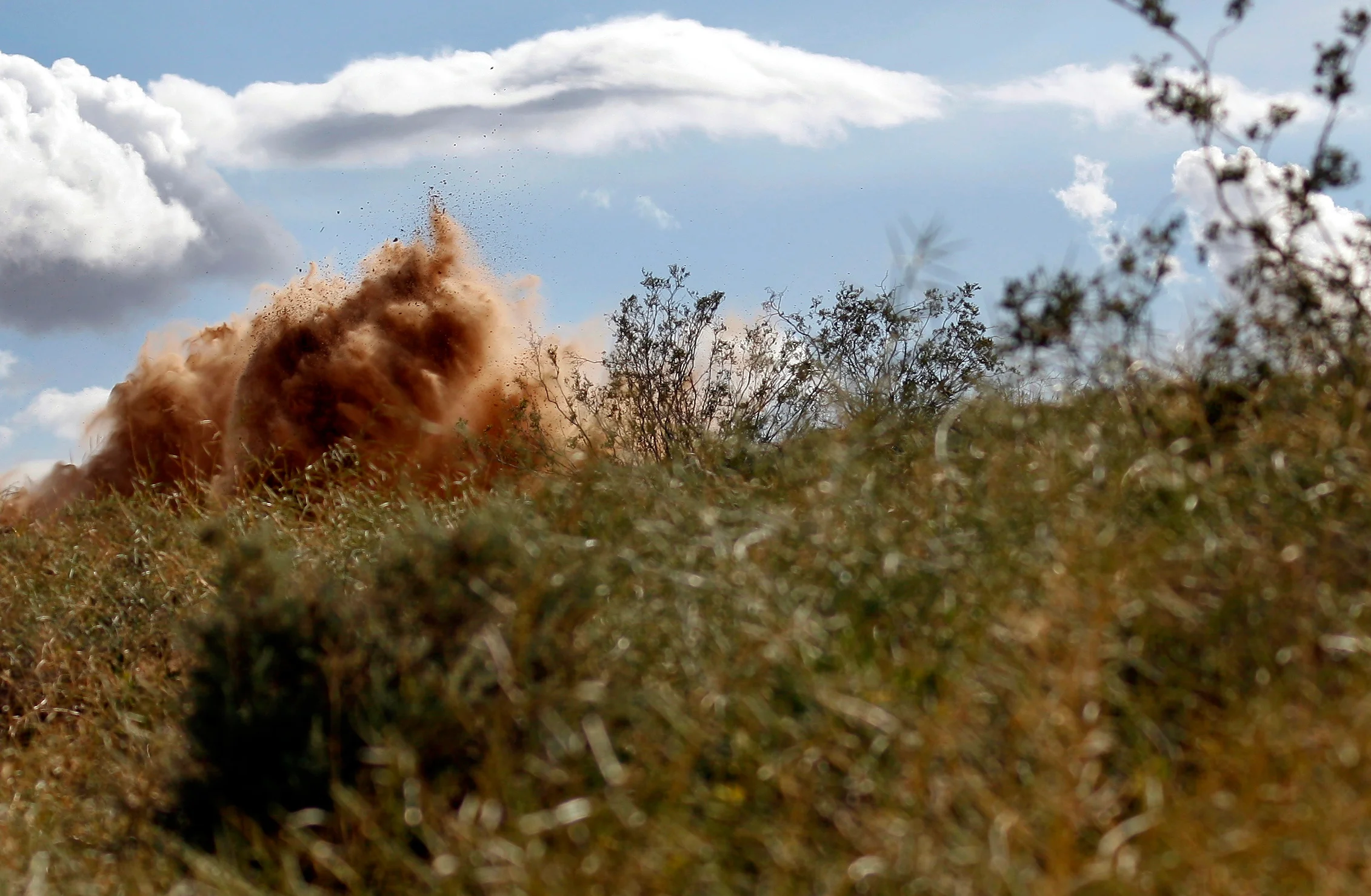  Dirt is kicked up from a race vehicle.&nbsp; 