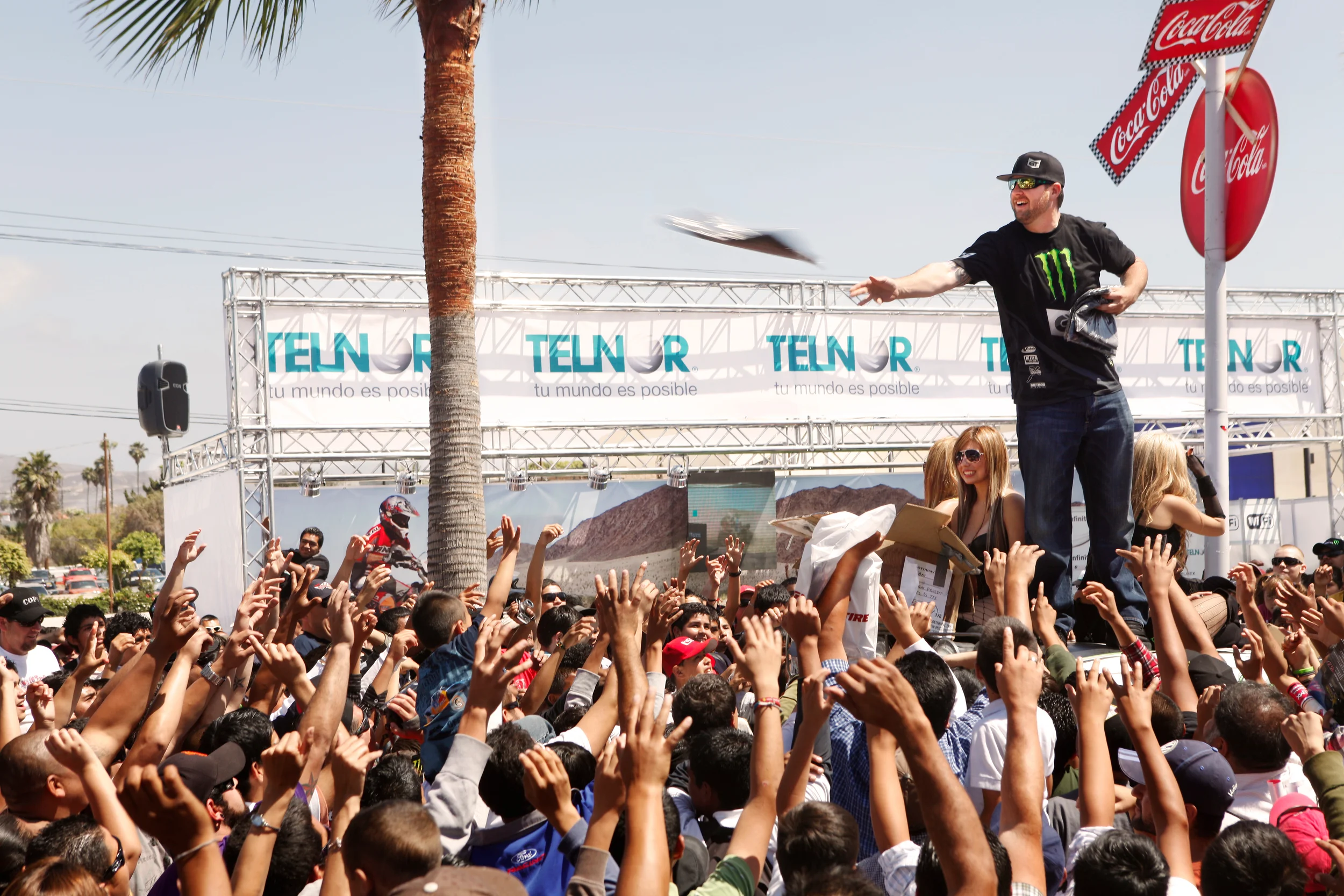  Race truck driver, the Ballistic BJ Baldwin, tosses out periphenalia to race fans from atop his truck in Ensenada, Mexico during the Baja 500.&nbsp; 