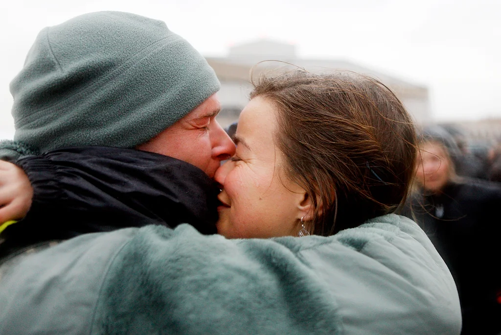  A soldier is welcomed home by his wife and child in Peoria, Illinois. 