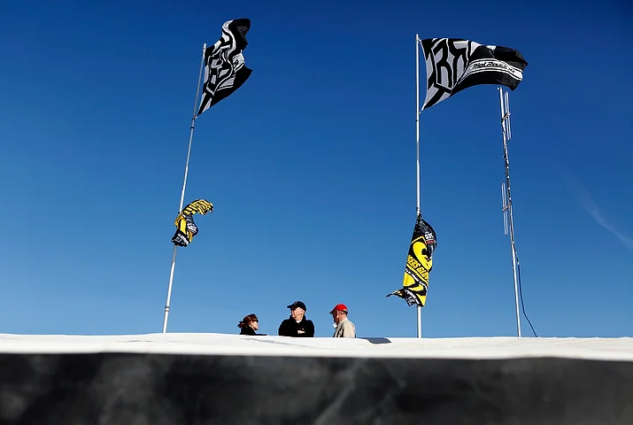   The race car driver's father and family watches trucks go by from the top of the trailer in Laughlin, Nevada.&nbsp;  