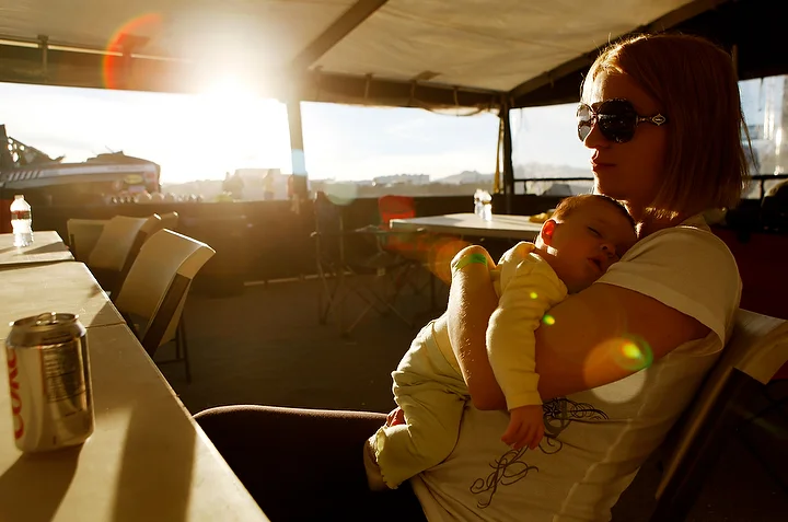  The race car driver's wife and new daughter sit inside the tent during the race.&nbsp; 