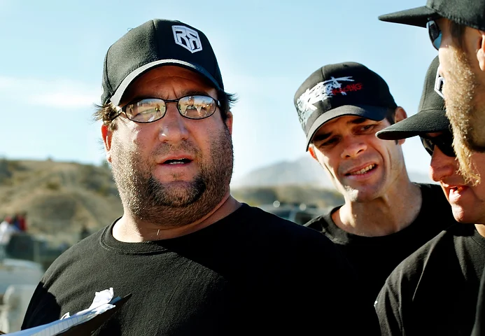  The team gathers around the crew chief Sammy Zaranti as they try to determine how their first place finish quickly vanished.&nbsp; 