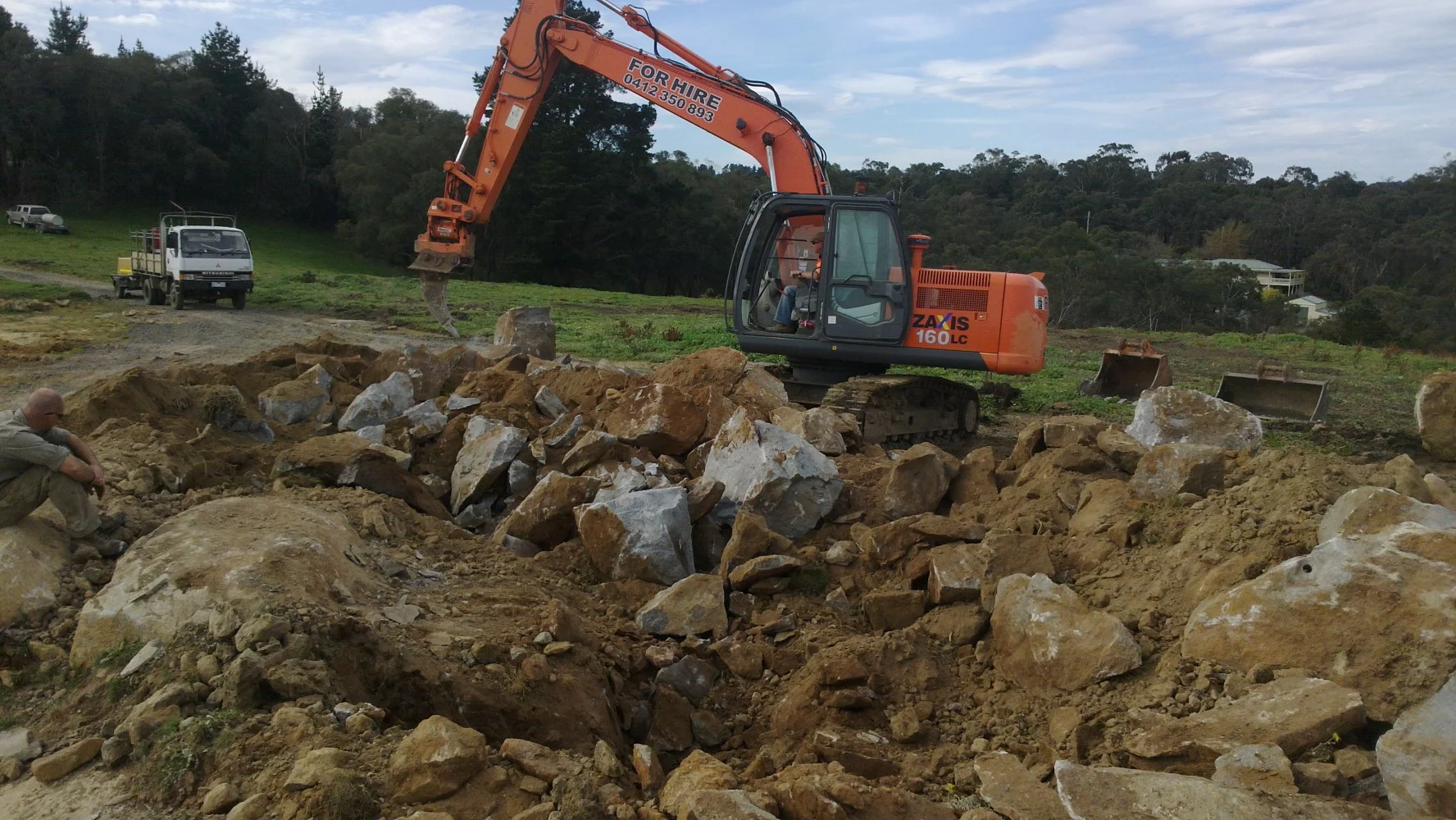 A site development project requiring extensive excavation, rock breaking, blasting and material removal