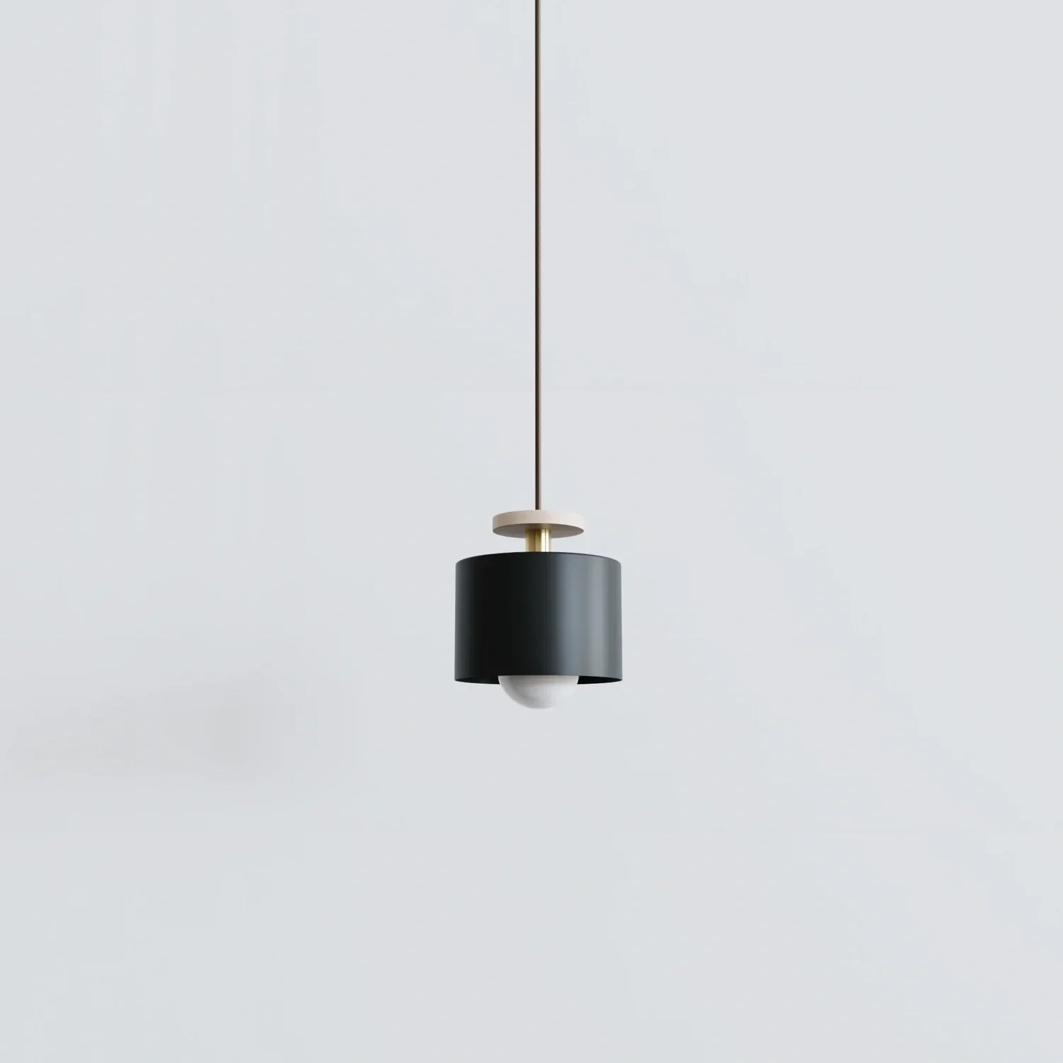 Spun pendant in matte black powdercoat with brass stem.