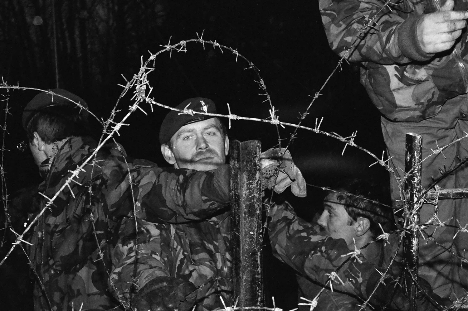  Paratroopers repair activist's damage to nuclear missile base perimeter fence, Greenham Common Berkshire, 1 January 1983. 