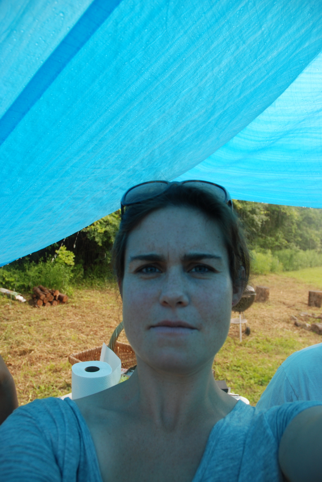 Self-portrait under tarp in rain