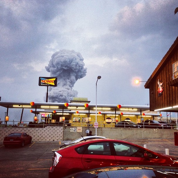   A plume of smoke rises from a fertilizer plant fire in West, Texas on Wednesday, April 17, 2013. The explosion at a fertilizer plant near Waco injured dozens of people and sent flames shooting high into the night sky, leaving the factory a smoldering ruin and causing major damage to surrounding buildings. Photo by Andy Bartee  