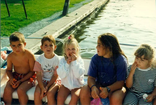 Chilling on the dock. I'm rocking a jailbird chic look. Note my messy hair + face (this lasts through 1999). I'm sitting with family friends. We were at their cottage in Lagoon City, on Lake Simcoe. 