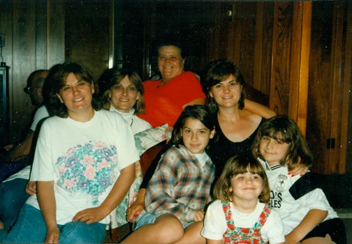 I think this photo is from 1996. My aunt was visiting from North Carolina (she opened a B&B in Asheville, NC). I had just finished playing soccer. Two of my aunts, my mom, my grandmother, my cousin + my sister are also pictured.