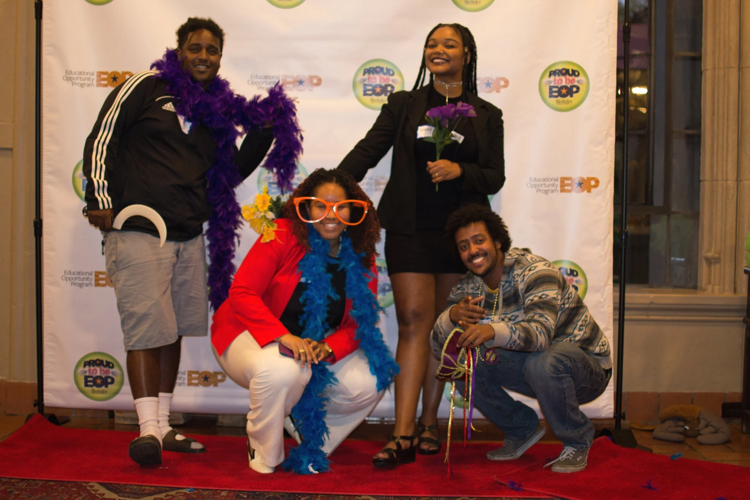 Four UC Berkeley students posing in front of the EOP picture booth stand