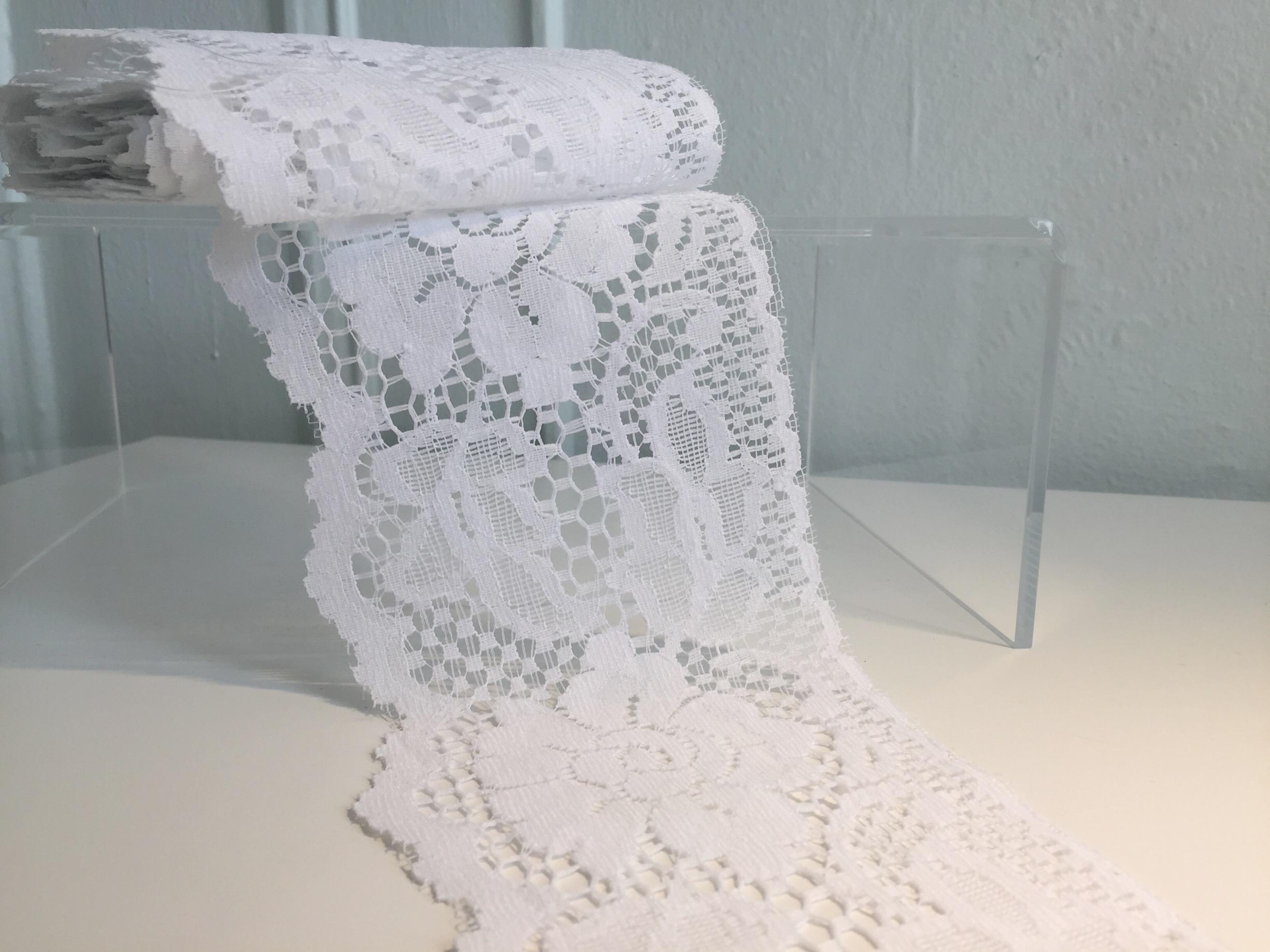 Leaver's lace: This is lace made on the Leaver's machine, developed in the early/mid 1800s from an adaptation of a net making machine and the jacquard weaving apparatus, which makes lace complete with the pattern, net, and outline, all at once. This machine-made lace incorporates some of the shading details found in finder handmade chantilly lace, without requiring a netting ground. It's generally flatter, and makes for a sturdy lace option, even if made in a more delicate design.