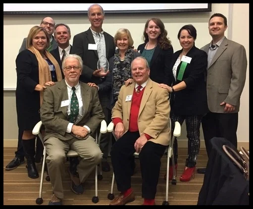 Past presidents gather around Thane Maynard. Back row, from left: Carrie Phillippi, Rob Pasquinucci, Mike Boehmer, Thane Maynard, Lee Oberlag, Shara Clark, Lauren Doyle, Jonathan Kissell. Front row, Rick Pender and Tom Schick.