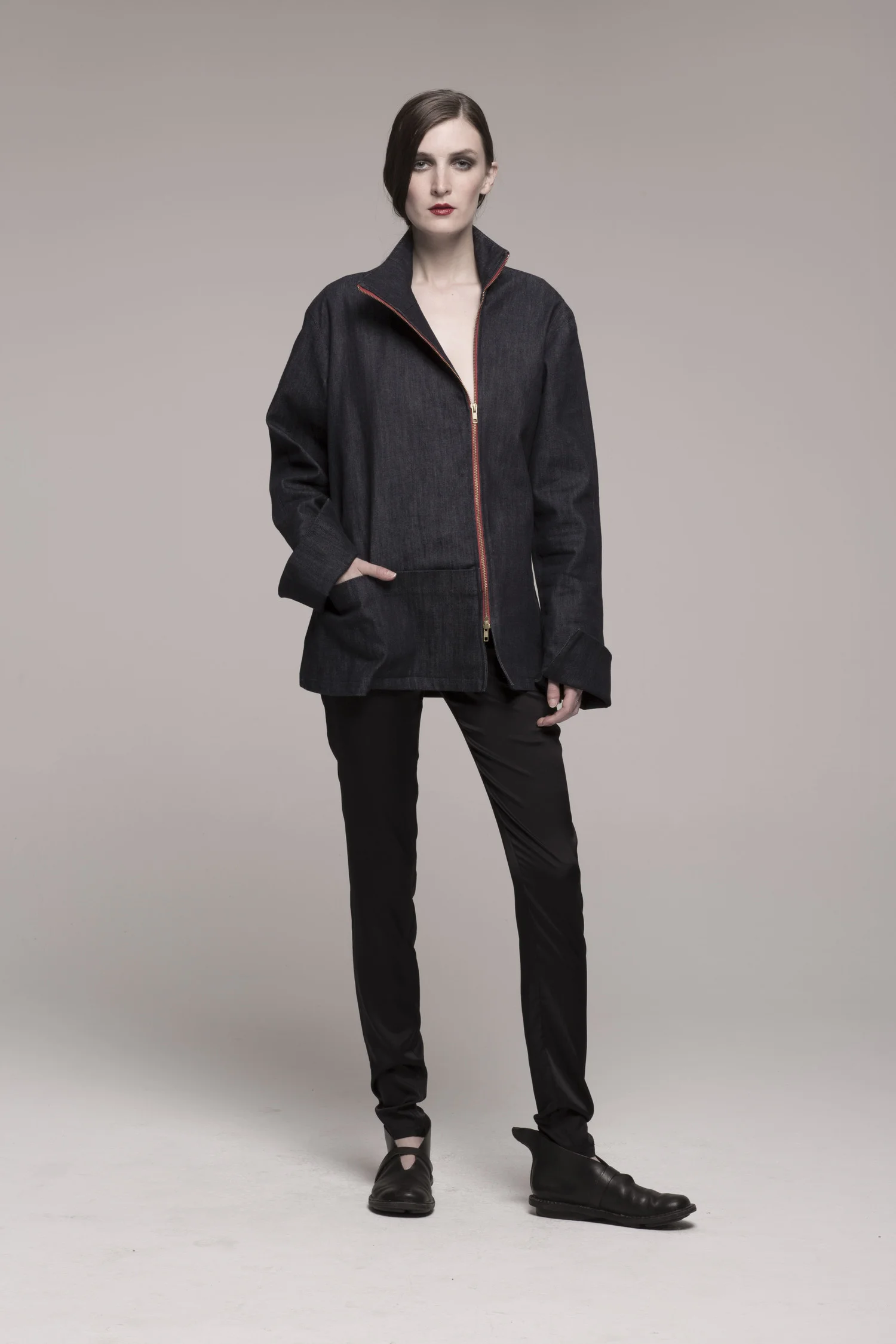model in denim pants suit, hand in pocket, facing camera