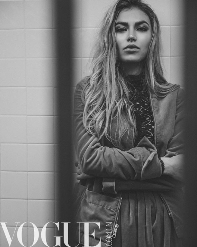 model leaning against NYC subway wall in jacket by Marine Penvern, Vogue magazine