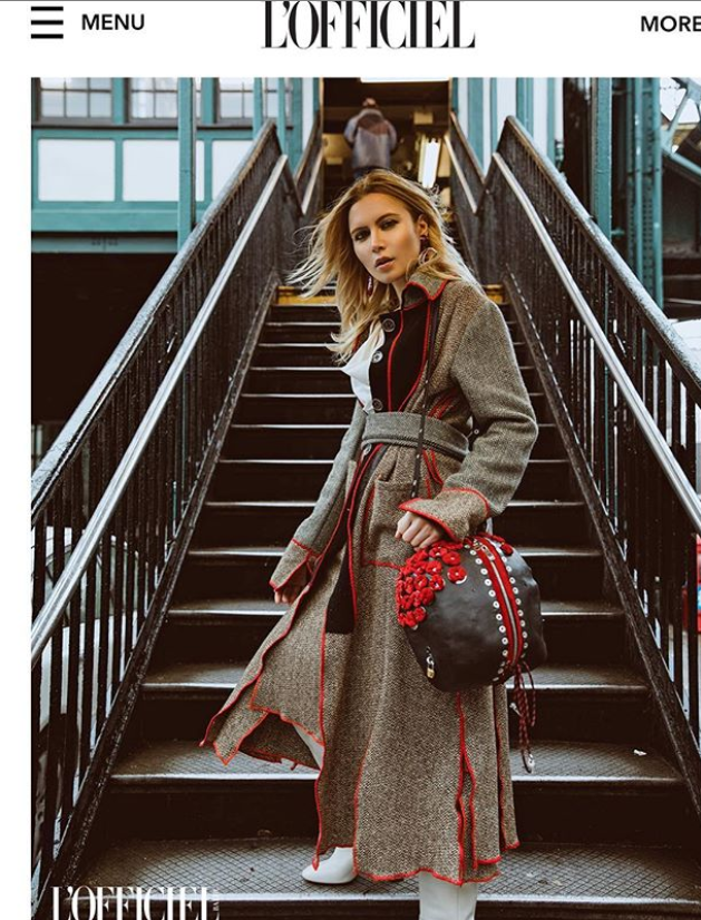 model in long gray coat with red piping by Marine Penvern, L'Officiel magazine; set on NYC subway stairs
