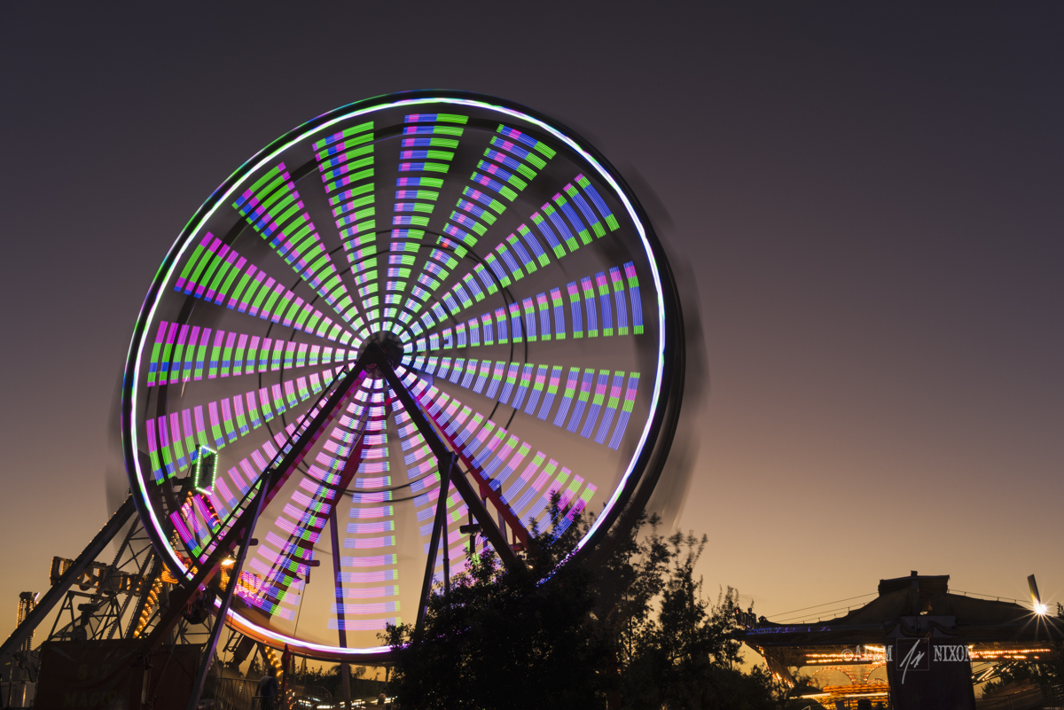 Spinning ferris wheel at twilight