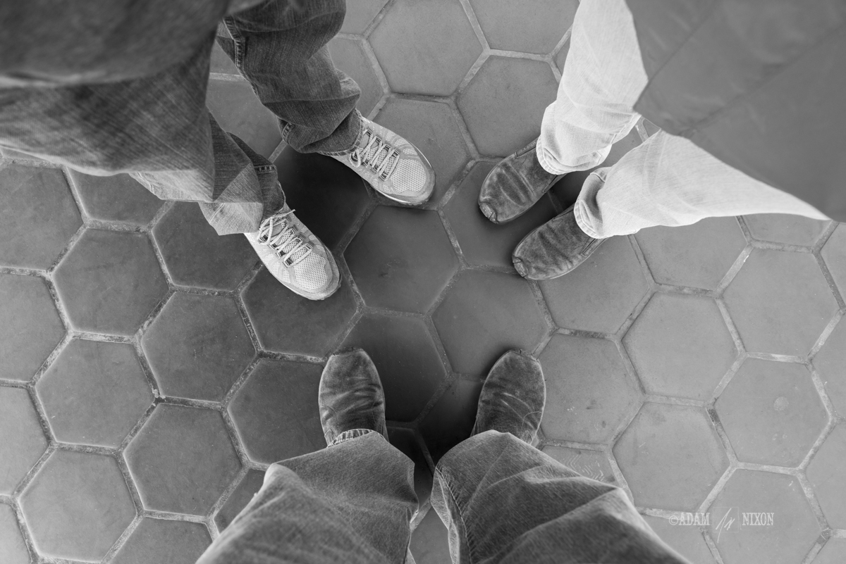 Looking down at the feet of a family of three