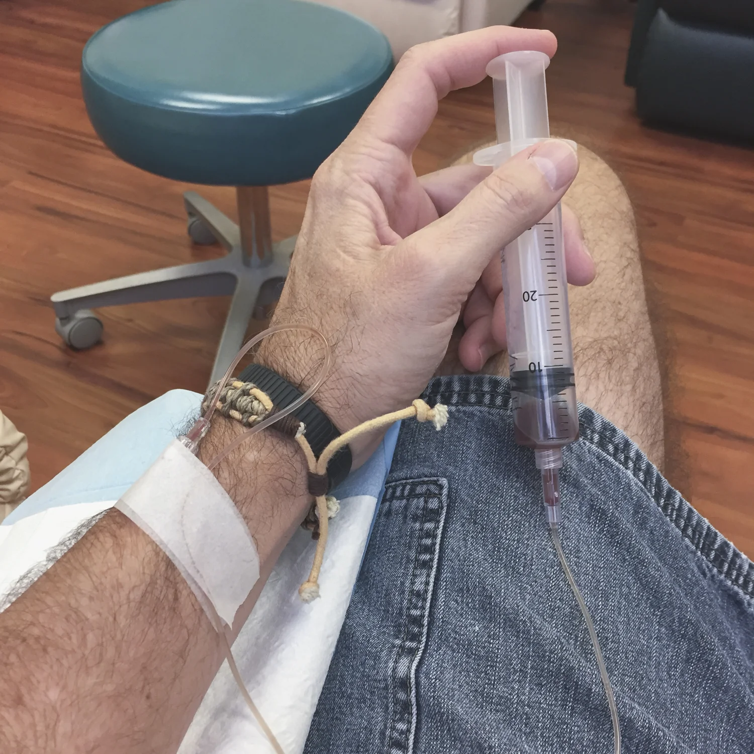 Man getting vitamins intravenously with a syringe