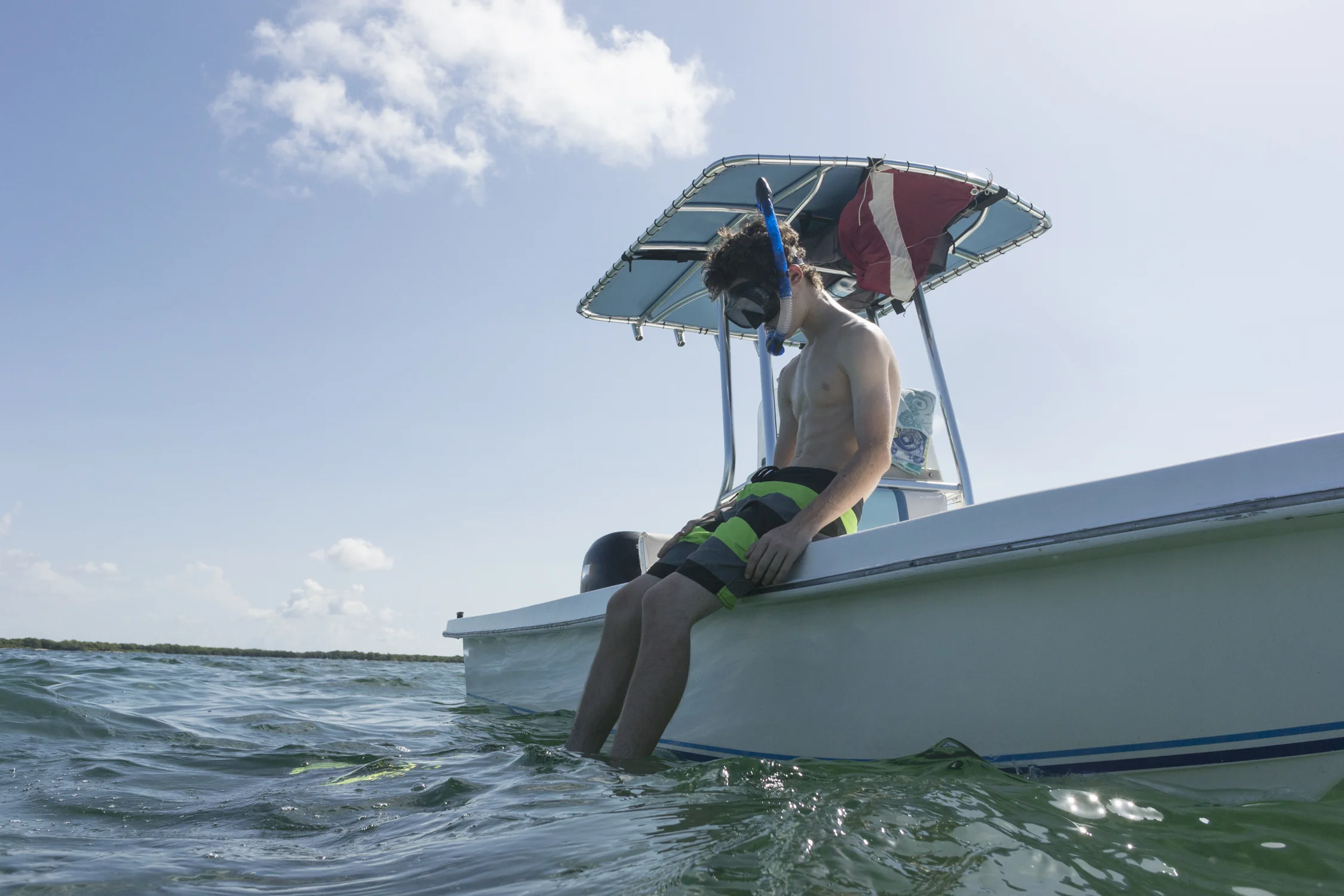 Teenage boy preparing to go snorkeling