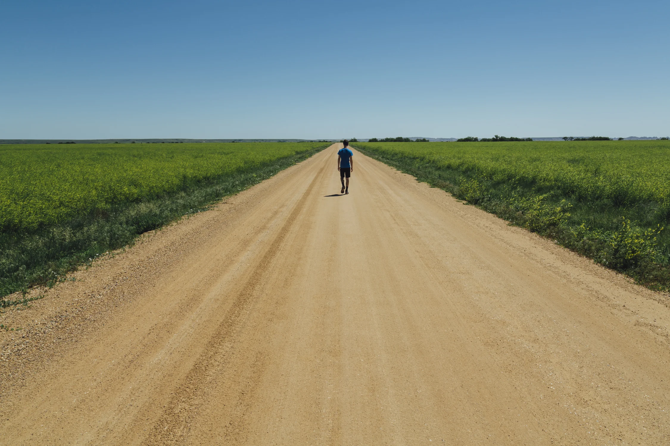 Teenage boy walking on a dirt road