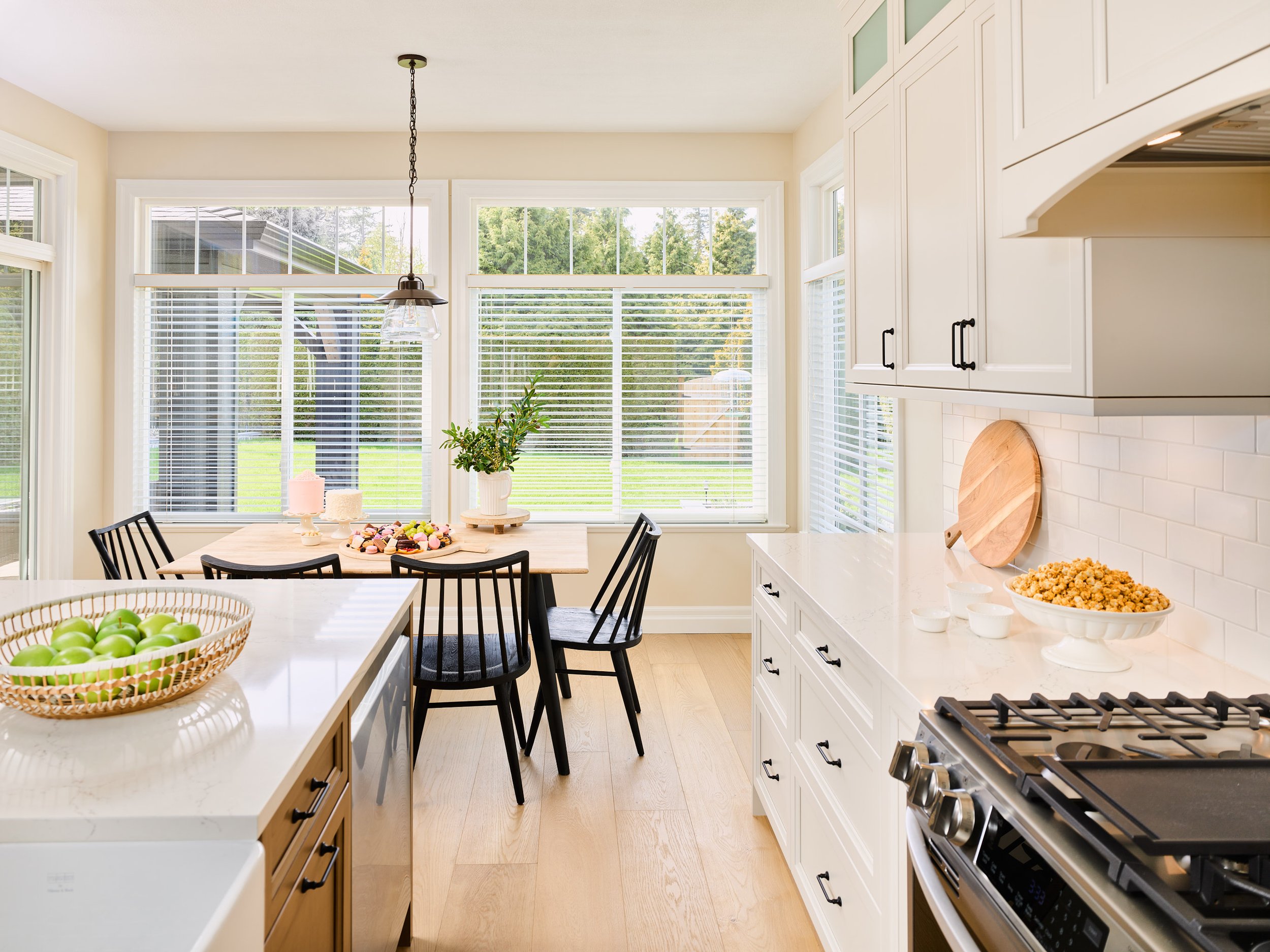 The extra wide white oak floor planks add so much warmth to this bright kitchen.