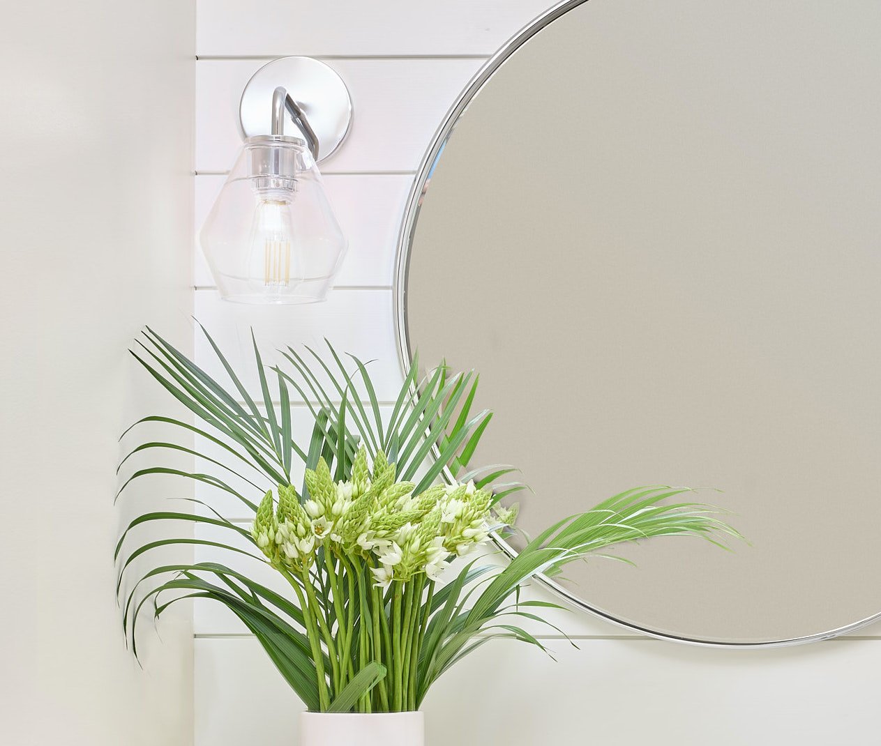 Polished chrome accents sparkle in this powder room.