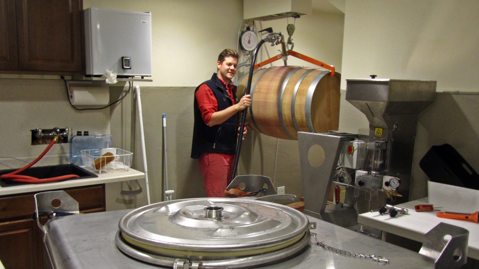 1 David Fenyvesi moving wine from barrel to mixing tank