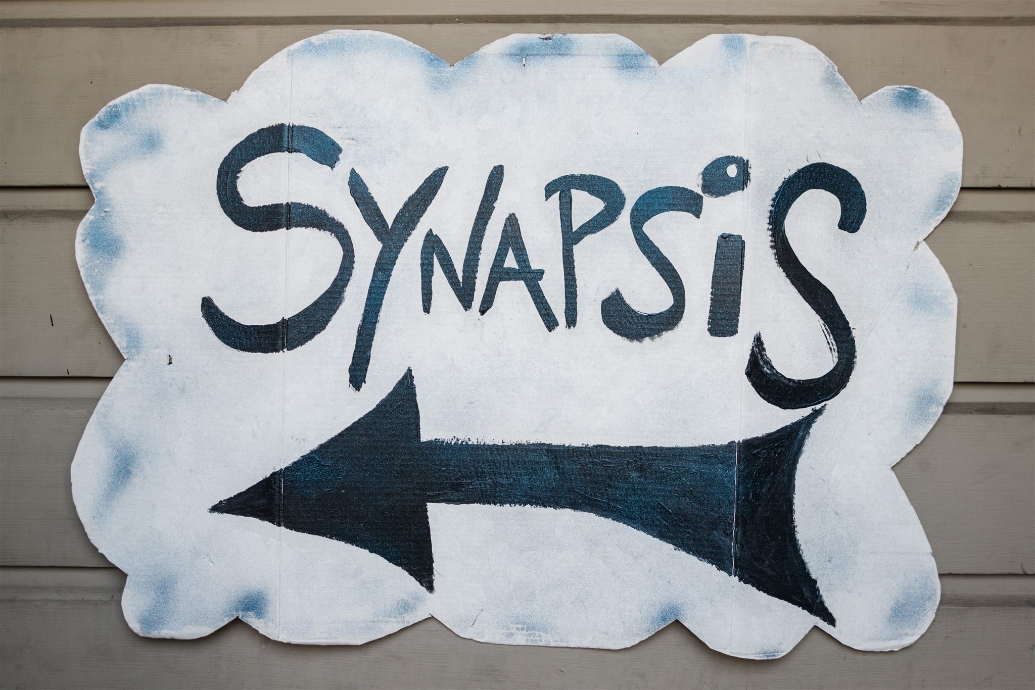 The original painted sign outside of Synapsis Union.