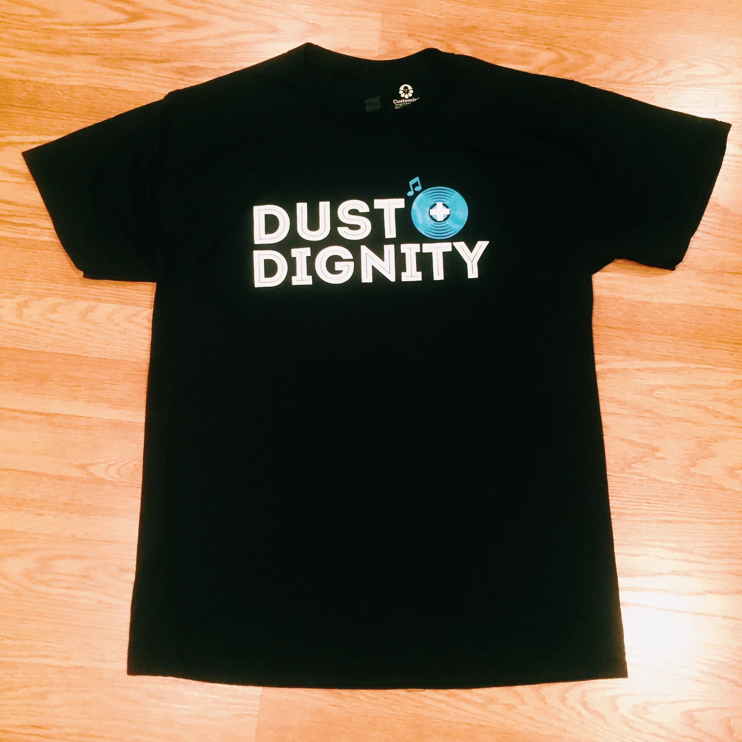 O fficial Dust+Dignity t-shirt We did a limited run of these t-shirts and have them available in unisex sizes: medium, large, xlarge and xxlarge . ( Please let us know what size you want . ) These shirts are tagless which means never having an itchy neck again! The shirts are 100% pre-shrunk poly/cotton blend. They also have a coverstitched collar for comfort and a double-needle stitched for durability. Order the limited edition shirt HERE 