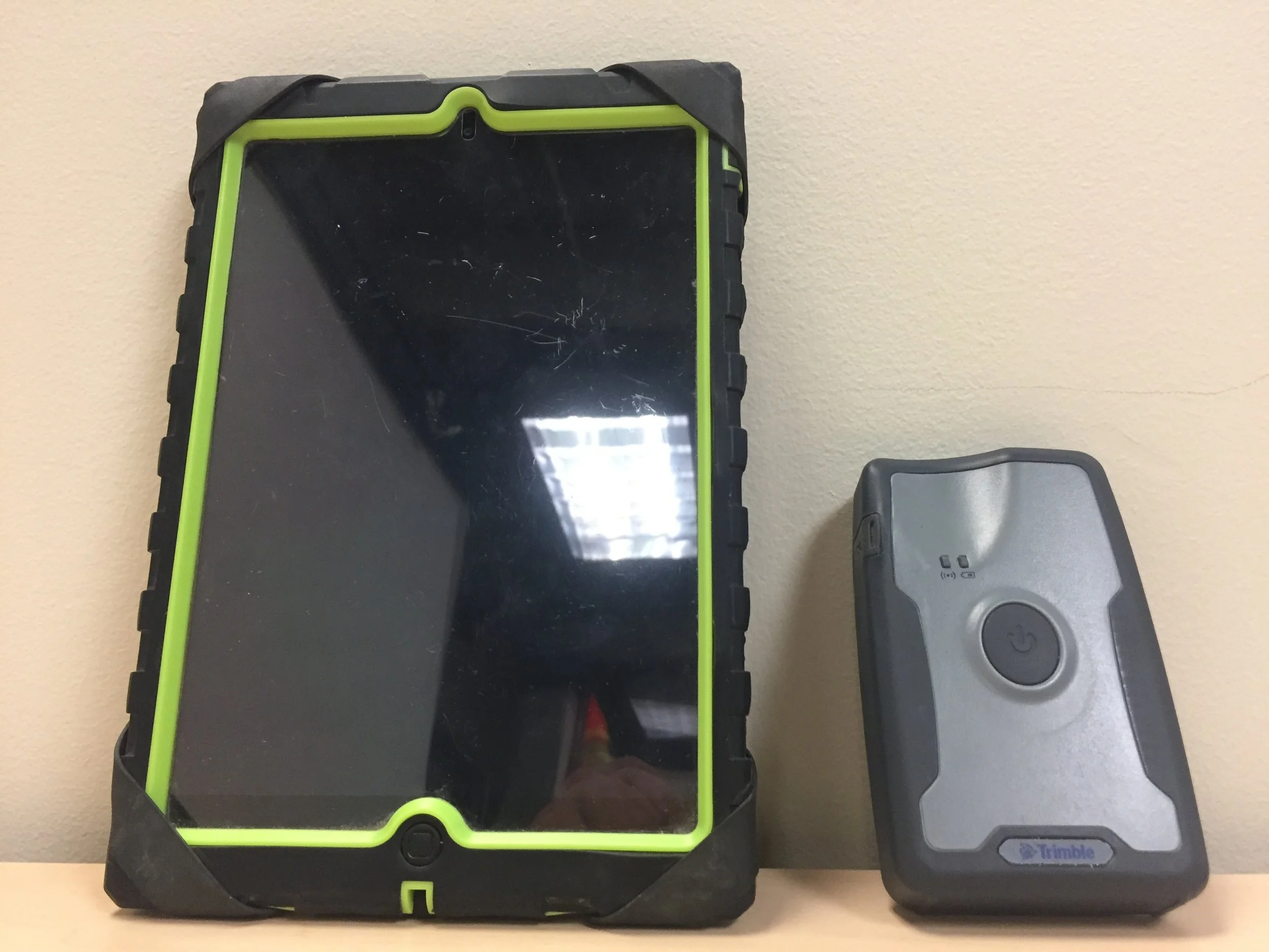 Apple iPad Mini (left) and the Trimble R1 Submeter (right)