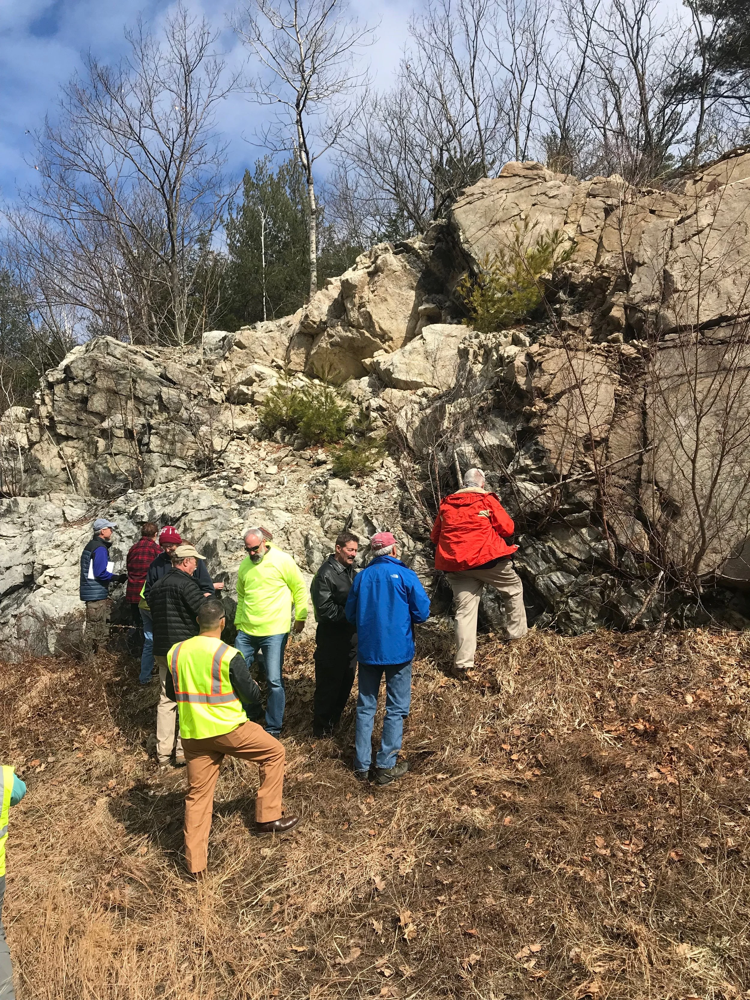 Geologists love a good roadcut! A quartz syenite ring dike intrudes the pre-Mesozoic tonalite with mylonitization at the contact.