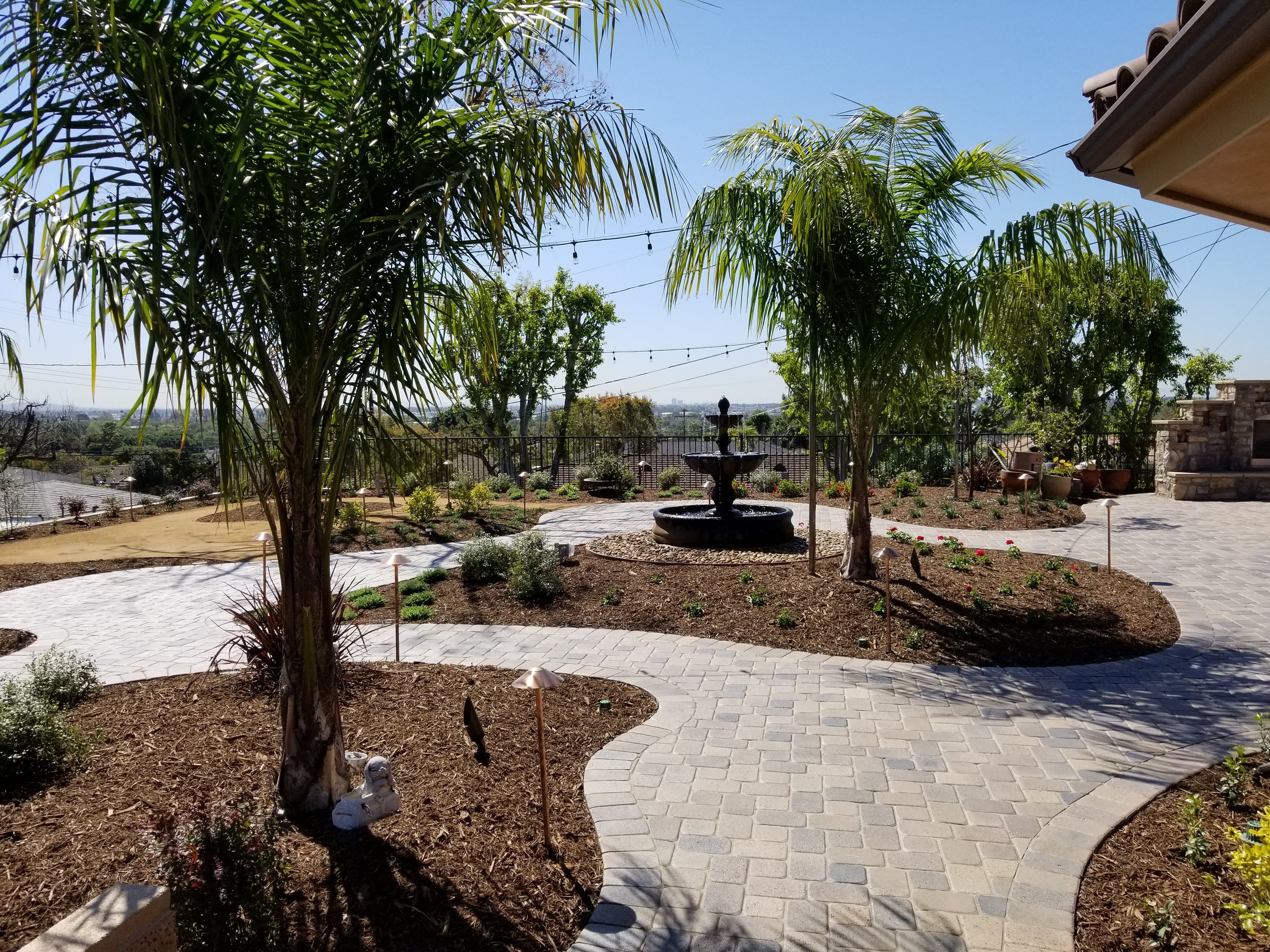paver walkway fountain trees drought tolerant