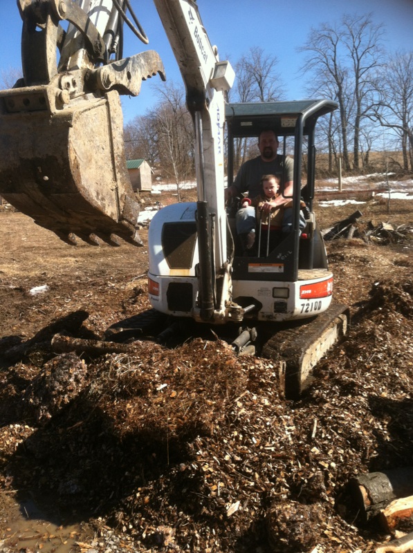 Some wet spots were filled in with mulch. More importantly, Henry got to sit in the digger, something he has been waiting months to get to do . 