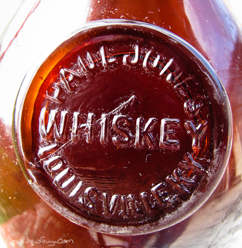 Glass seal affixed to the shoulder of 19th Century Paul Jones Whiskey bottle.