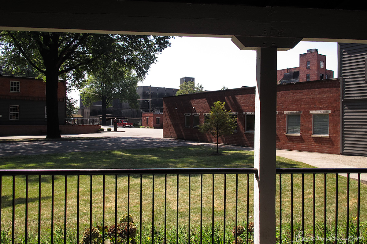 The tour to this point. The building on the right is the gift shop. Tour started there. The black buildings in back are more warehouses. That was the first stop where we "learned" what the black fungus...err..."active alcohol?" was. The brick and gray building to the left is where "their still" is.
