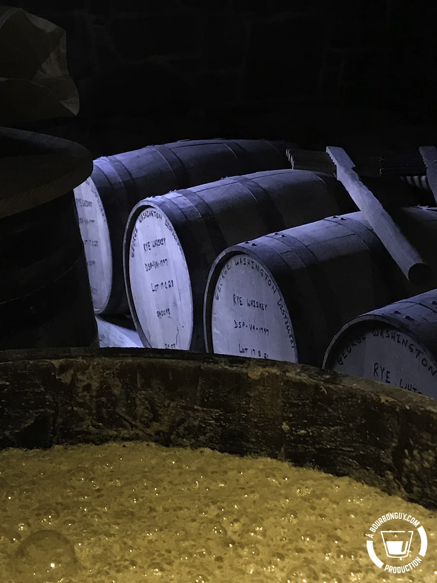 Fermentation in a barrel with unused barrels and a mash rake behind