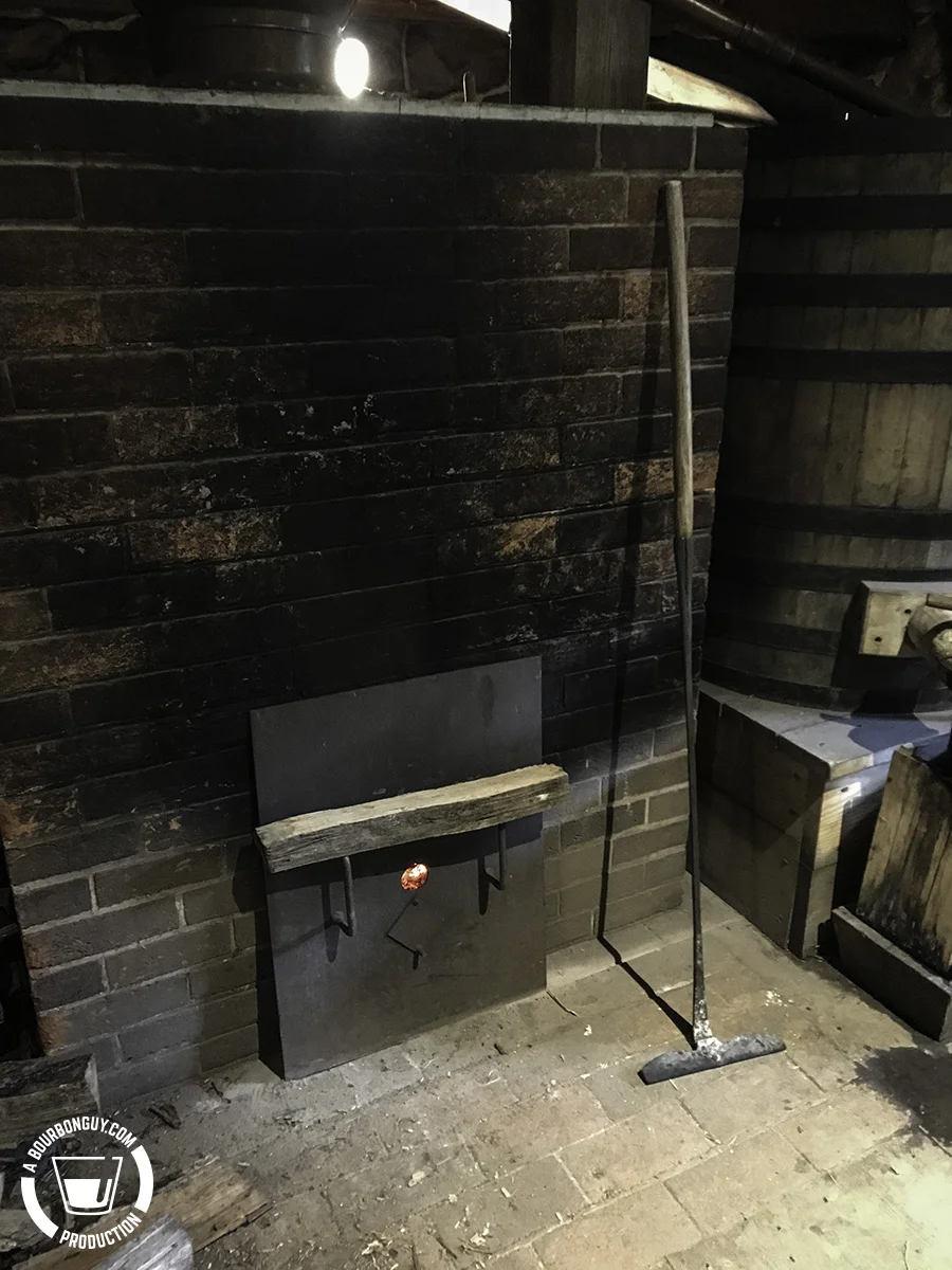 A block of wood across the fire box handles signifies that there need be no more wood added as this distillation has ended for the day. 