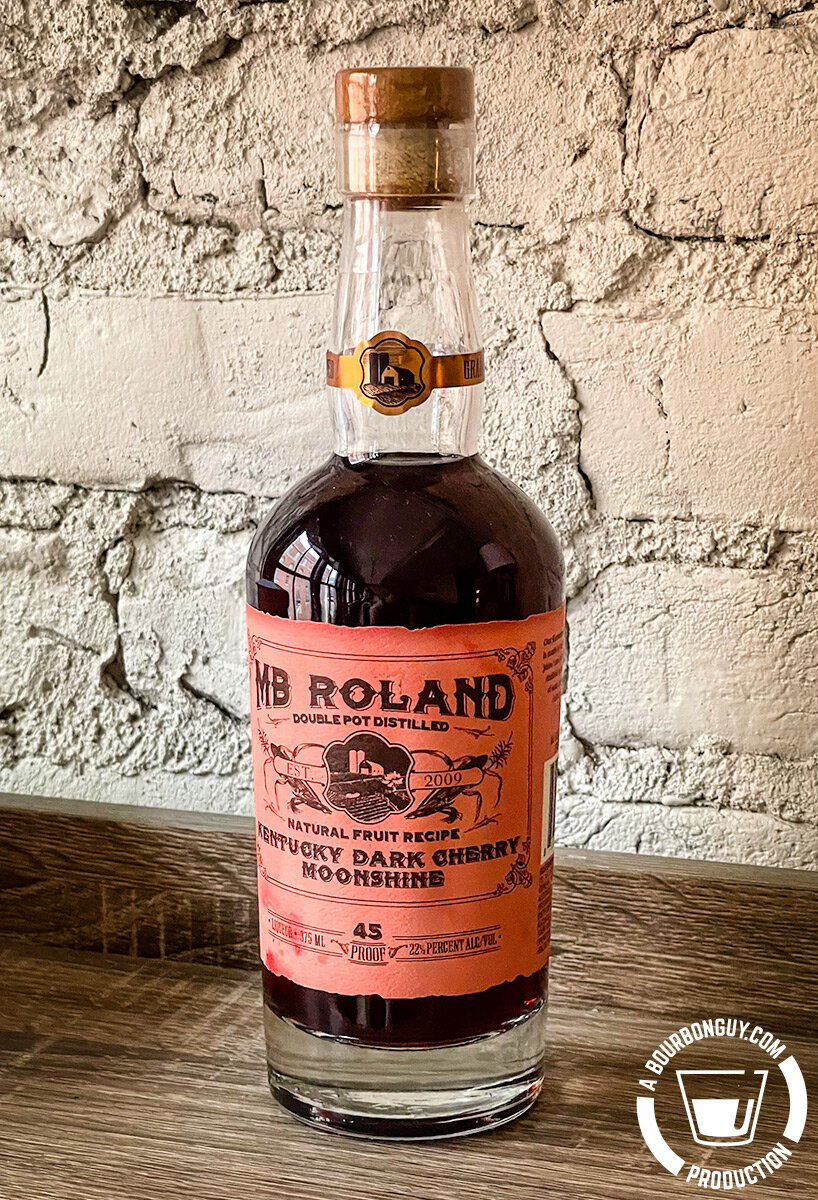 IMAGE: The pink labeled bottle of MB Roland Dark Cherry Moonshine