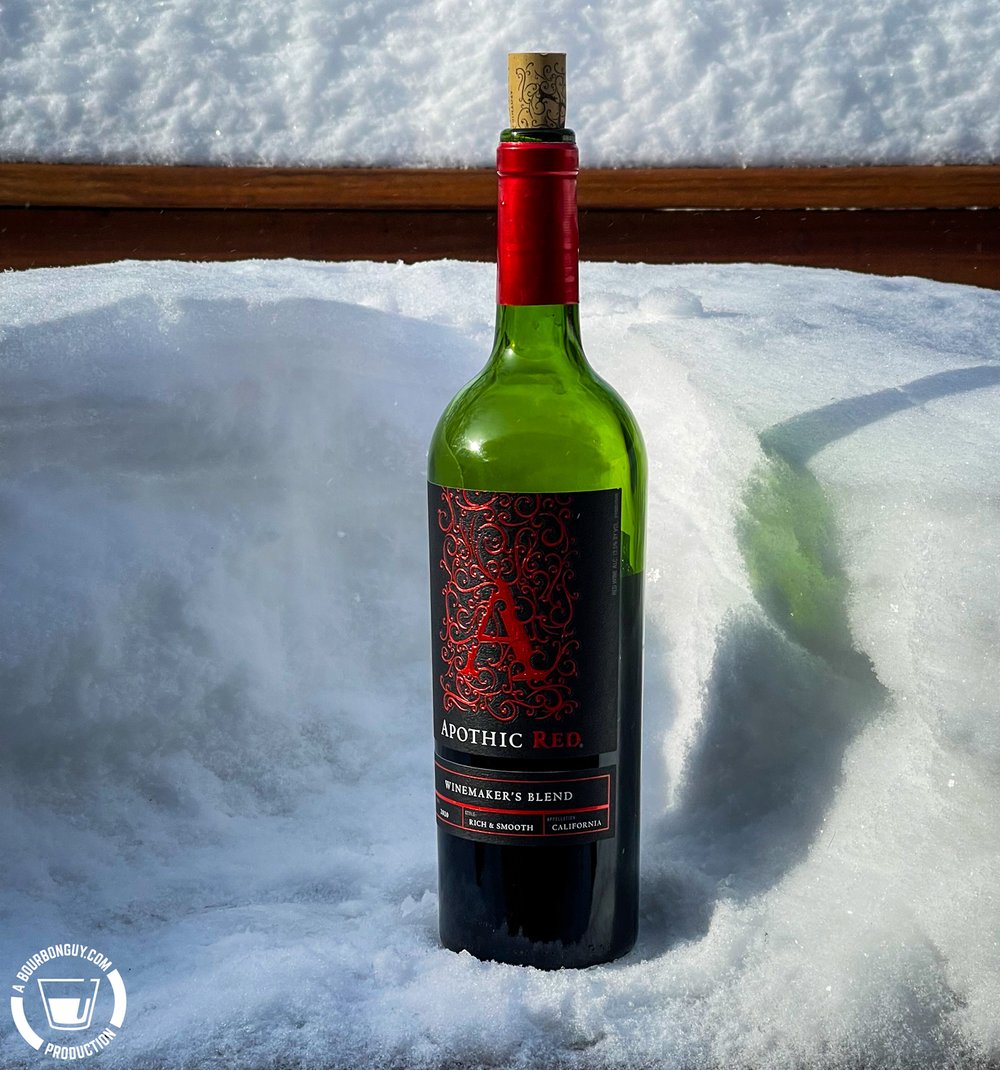 IMAGE: A bottle of Apothic Red Wine sitting in a foot of snow.
