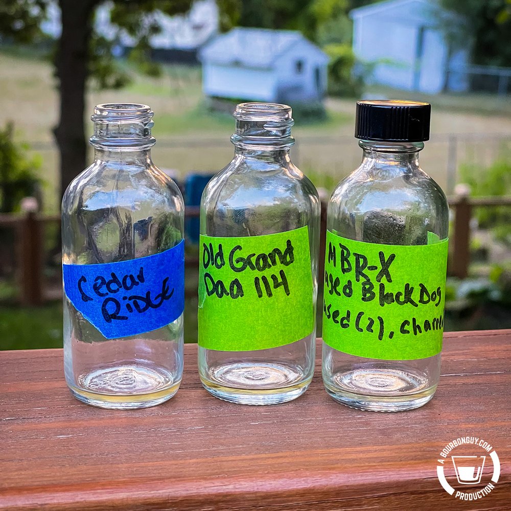 IMAGE: Three empty sample bottles. Cedar Ridge Iowa Bourbon, Old Grand-Dad 114 proof, and MB Roland Experimental aged Black Dog