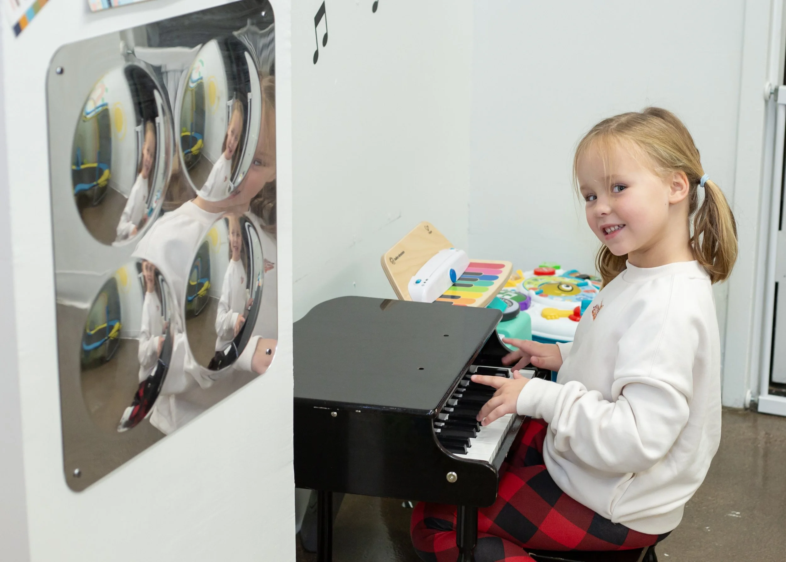 A child plays music inside this mesa arizona playspace and community space for parents