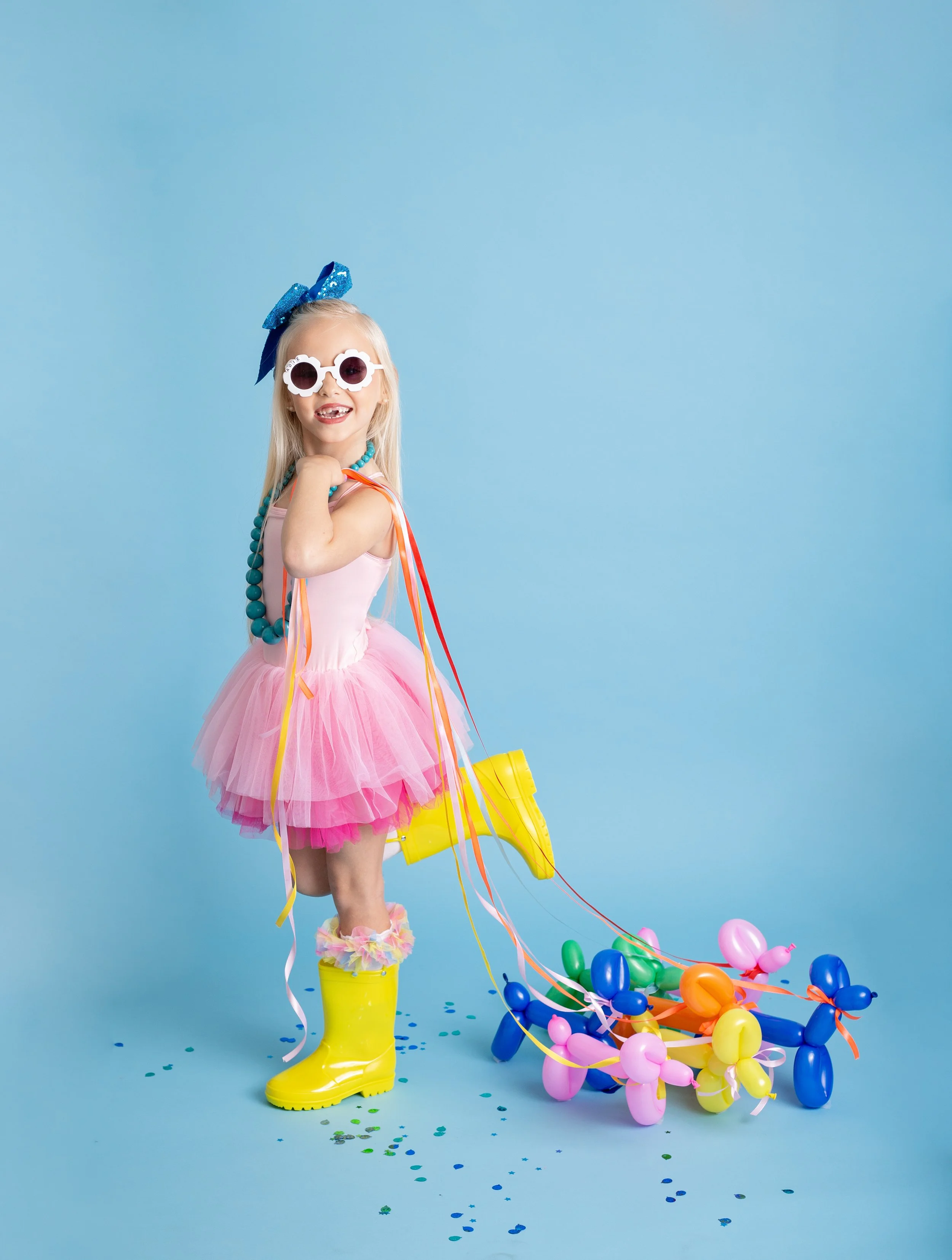 Bright and playful birthday photo of a girl holding a balloon dog, captured by a Gilbert, Arizona kids photographer.