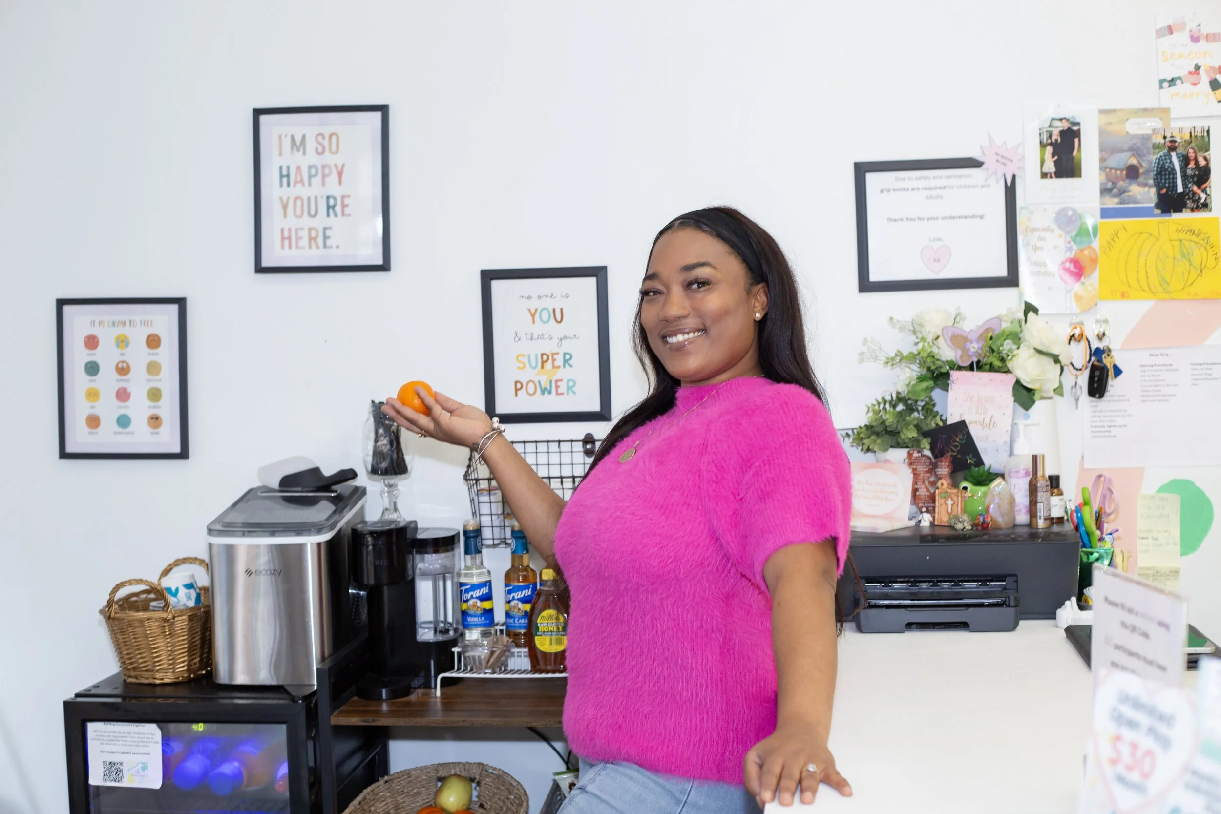 The owner of Kitten's Korner shows off her beverage station for parents