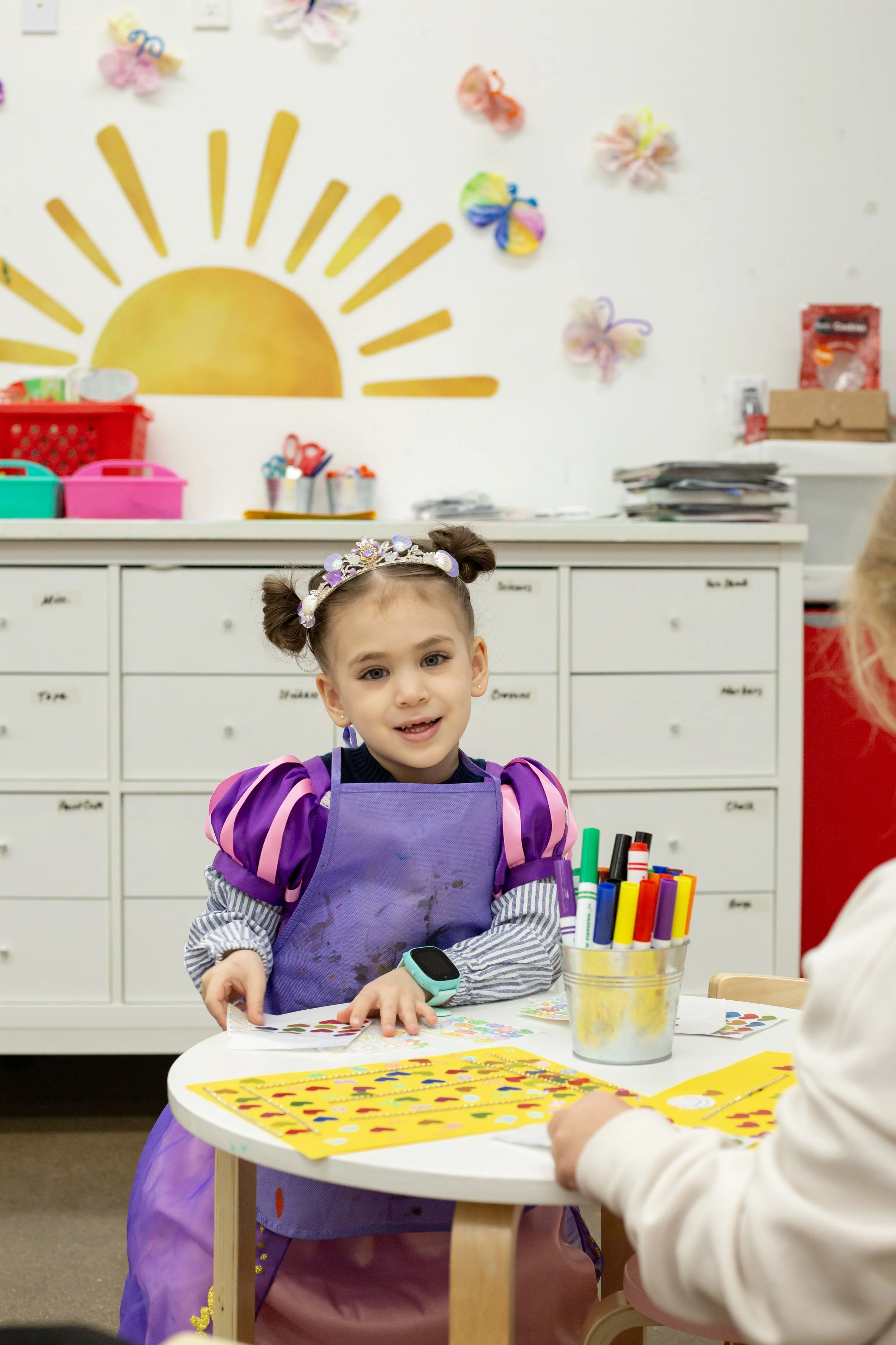 A child does arts and crafts inside this mesa arizona playspace and community space for parents