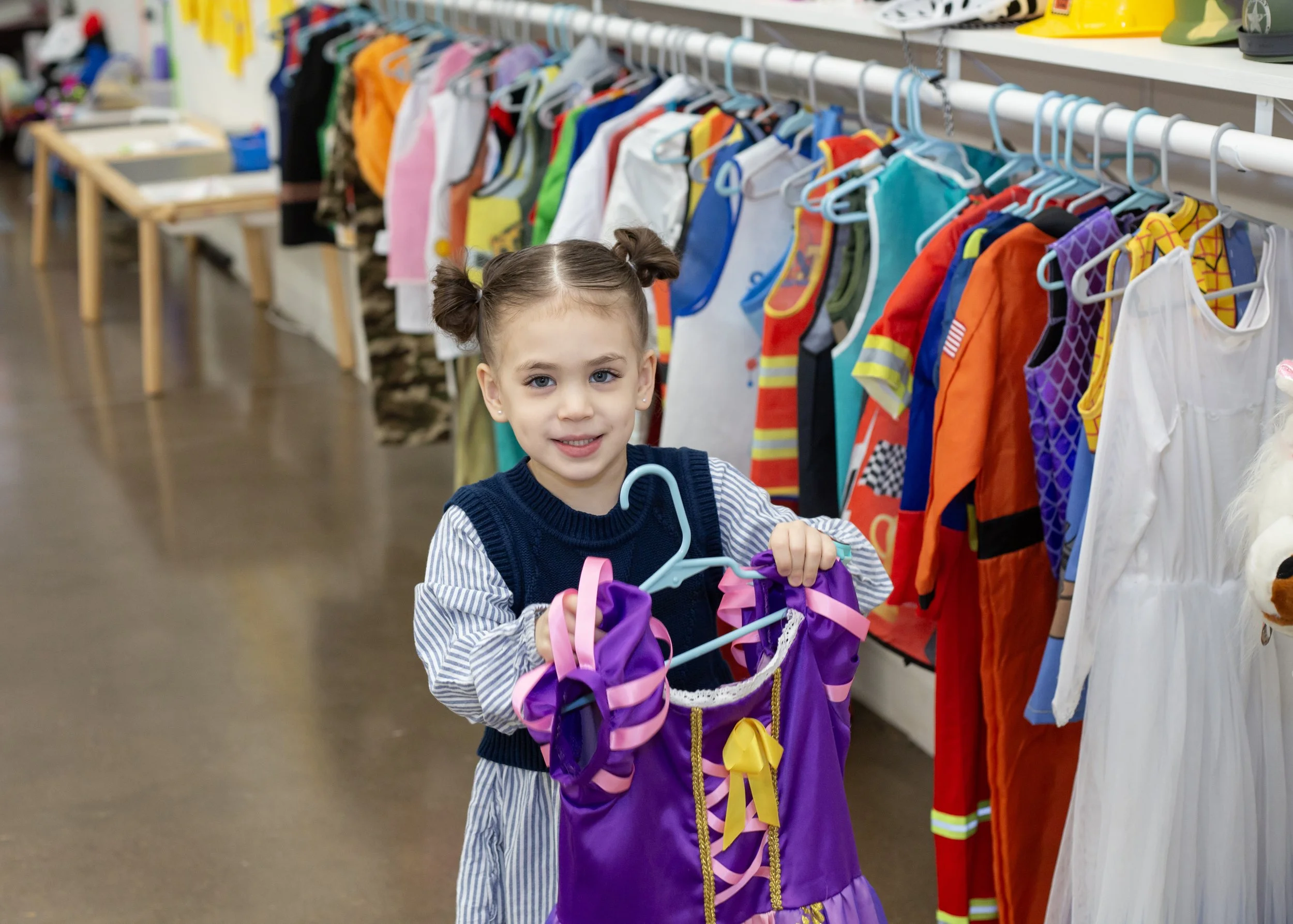 A child plays dress up inside this mesa arizona playspace and community space for parents