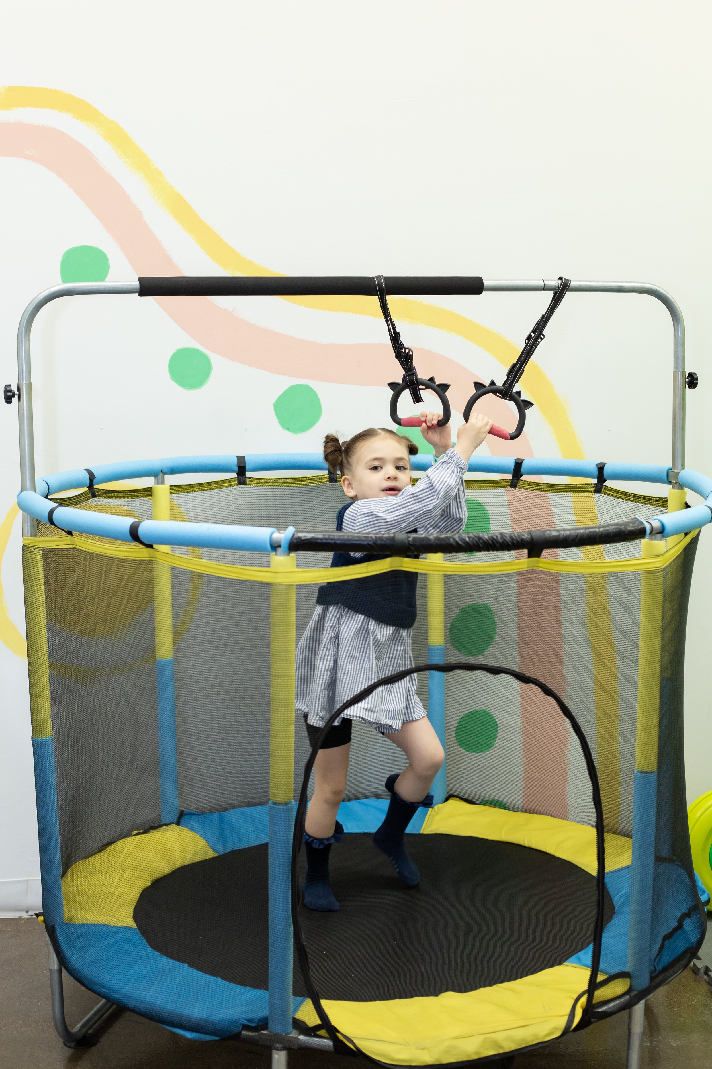 A child jumps on the trampoline inside this mesa arizona playspace and community space for parents