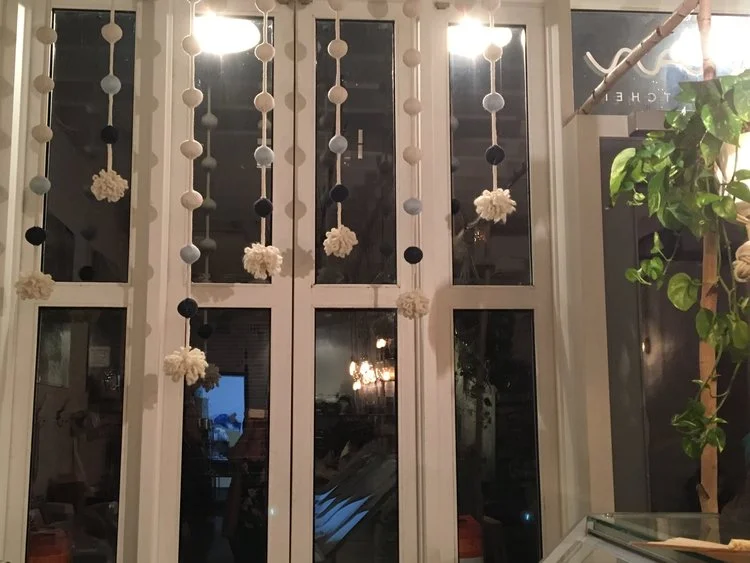 These hanging bobbles create more of an interior cozy feel at the Greenpoint Maman.